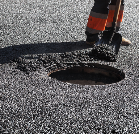 Man Shoveling Asphalt in Newark, NJ 